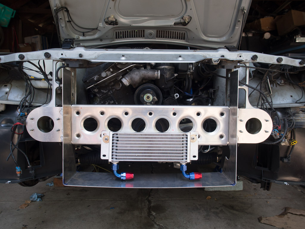 An aluminum crossmember has been made and attached between the two frame rails. A U-shaped aluminum air duct is welded to it and channels air into the radiator.