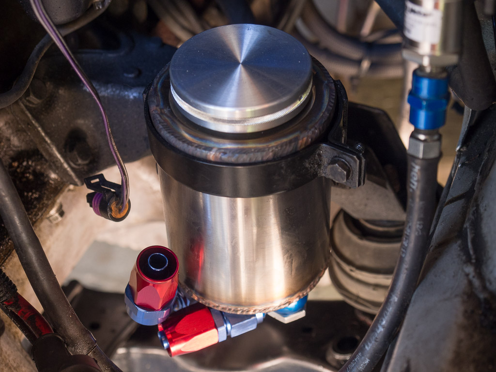 Custom machined power steering reservoir installed in the car as a mock up.
