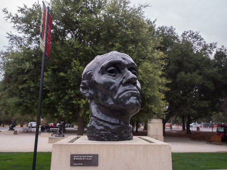 Bronze bust of Jean d’Are, Burgher of Calais. Photo taken several feet away with a wide angle lens. There is a lot of background environment present in the frame.