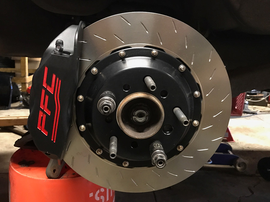 Photograph of a complete front brake assembly from the outside. Caliper, rotor, and pads in place.
